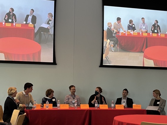 Seven people gathered at a table for the Cassandra at TADA roundtable